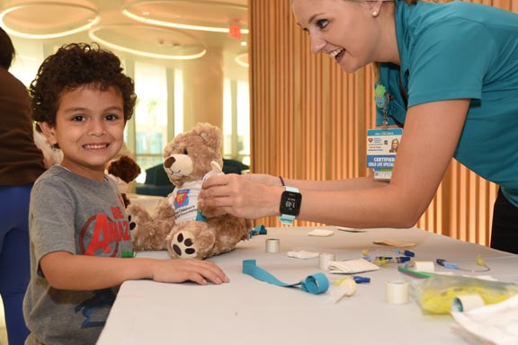 child getting golden teddy bear